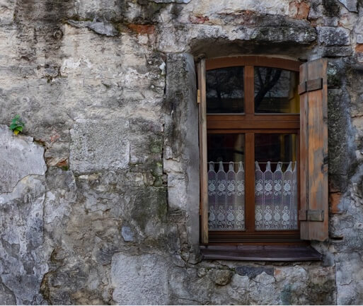 a open wooden window in a stone wall